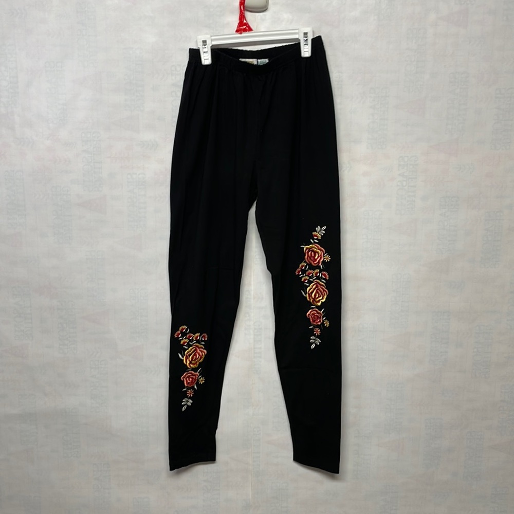 Women Collections brand black stretch pant with flower embodied detail